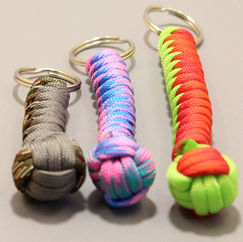 Drei handgefertigte Paracord-Schlüsselanhänger in verschiedenen Farben